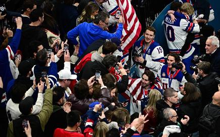 Quinn Hughes (L), Jack Hughes and Matthew Tkachuk (R) celebrate with fans after winning the medals ceremony of the men's ice hockey event. Pic/AFP 